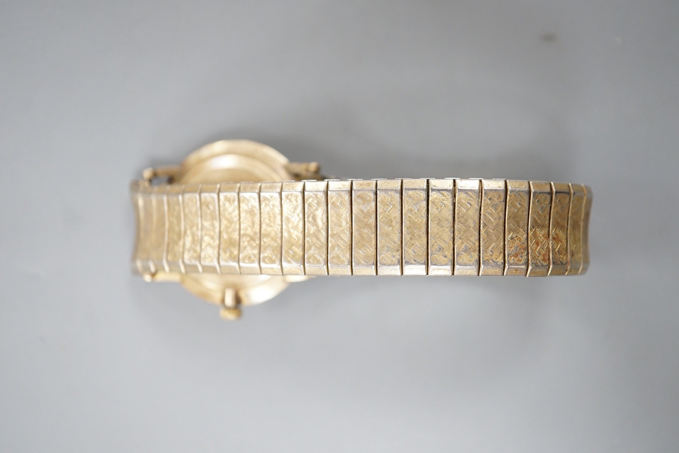 A gentleman's 9ct gold Longines Cosmic manual wind wrist watch, on associated flexible bracelet.